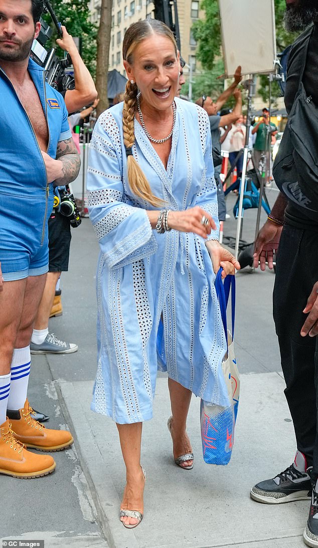 The 59-year-old actress wore a baby blue trench coat-style dress with scattered triangular cutouts