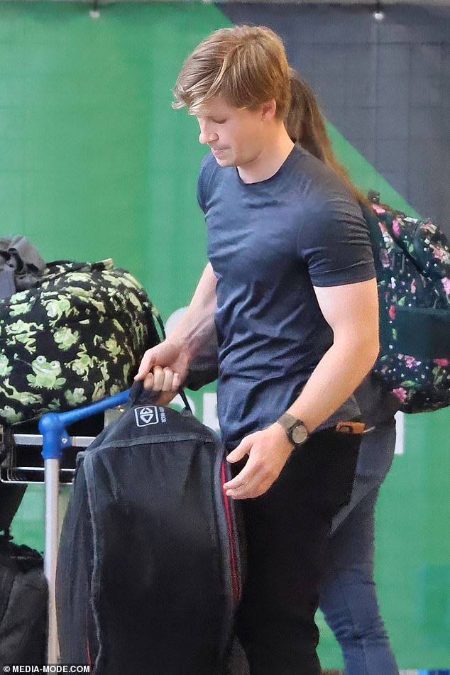 Robert kept his eyes on the crowd as he left the airport with a large amount of luggage