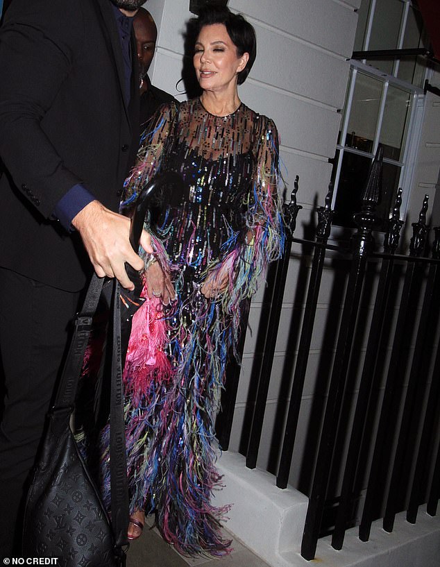 The Kardashian-Jenner matriarch wore a figure-hugging solid black dress underneath the sheer, long-sleeved creation