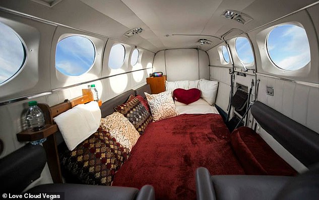 The Love Cloud aircraft interior (above) features a spacious bed, sheets, blanket, pillows and seats for take-off and landing