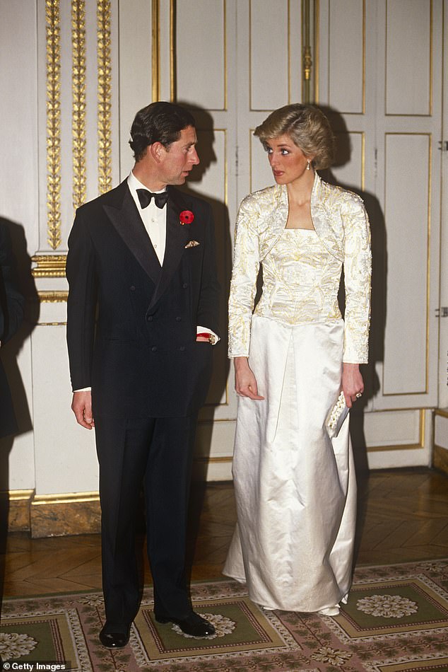 An edgy Princess Diana in a cream-colored silk dress with Prince Charles during a visit to Paris in 1988
