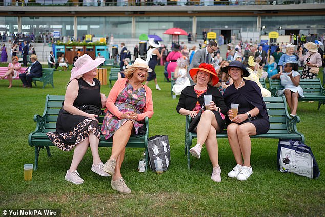 IN A GOOD SPIRIT: These women were pictured holding their drinks as they laughed together and enjoyed the atmosphere