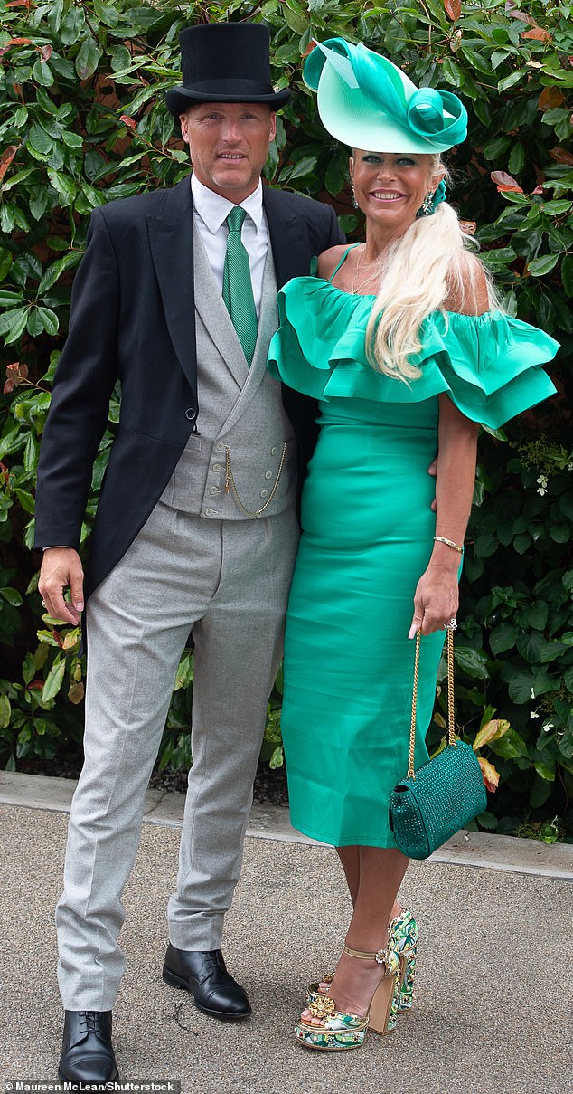 The couple subtly coordinated their outfits, with the woman opting for a green dress, while the man wore a tie in the same color.