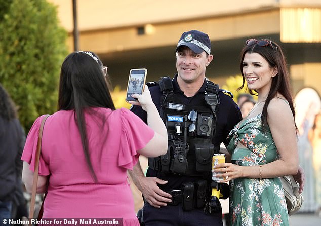Even police officers got into the festive spirit by posing with the colorfully dressed racegoers