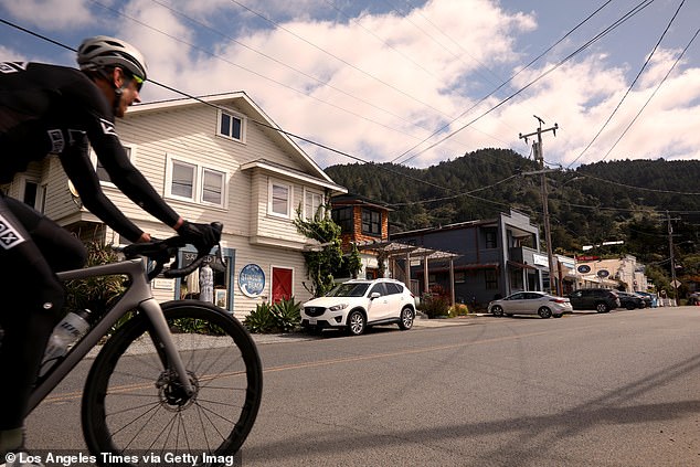 A study has found that Highway 1, the road that takes people in and out of Stinson Beach, could experience more storm flooding by 2050 as sea levels rise two feet.  (photo: a cyclist riding along Highway 1 in downtown Stinson Beach)