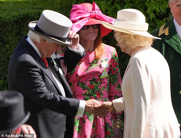 The American actor and director was seen removing his top hat as he shook hands with Queen Camilla
