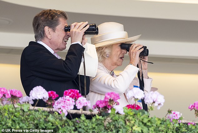 Race manager John Warren and Queen Camilla (both pictured) watch the racing through binoculars