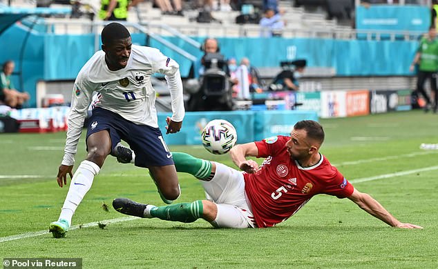 Attila Fiola slides into French winger Ousmane Dembélé during a match at Euro 2020...