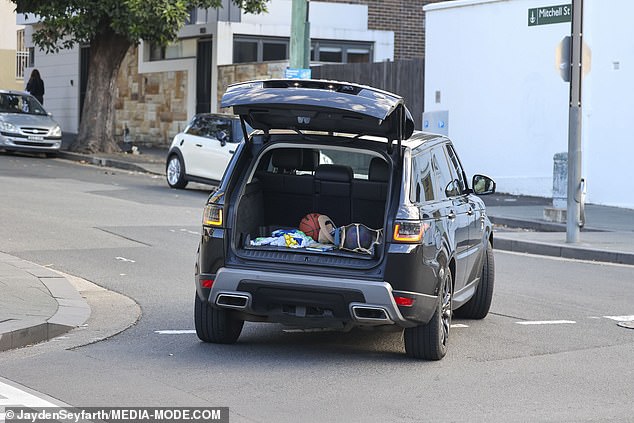 But with her mind elsewhere, the fitness guru completely forgot to close her boot as she rushed down the road with all her personal belongings out in the open.