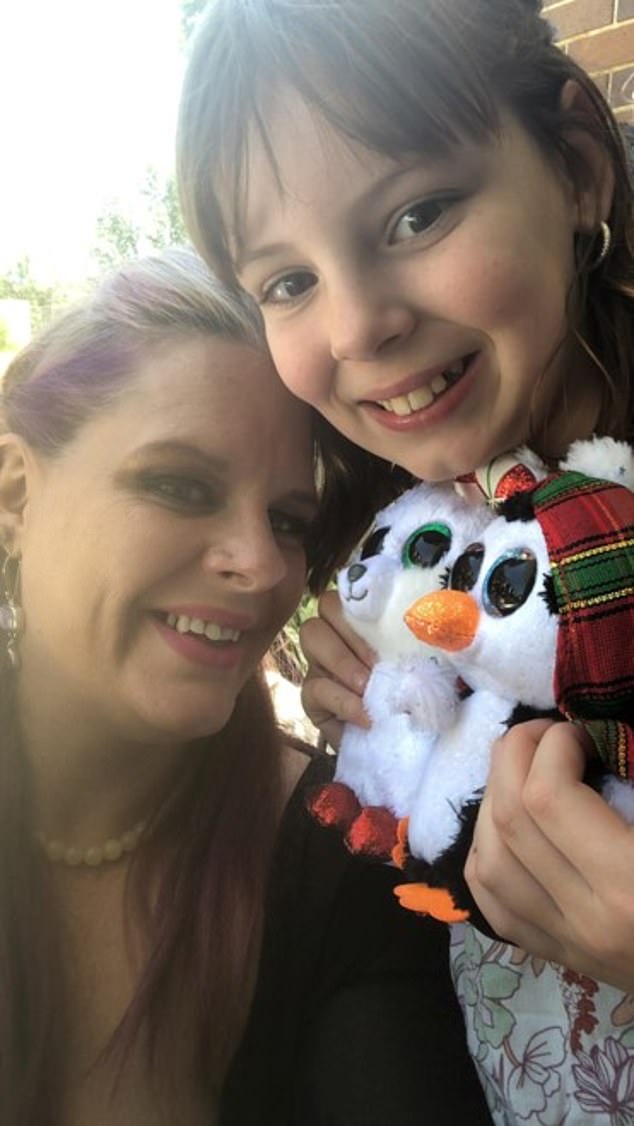 Charlise holds a toy and looks happy next to her mother, Kallista Mutten, on Christmas Day 2021, blissfully unaware of the horror to come