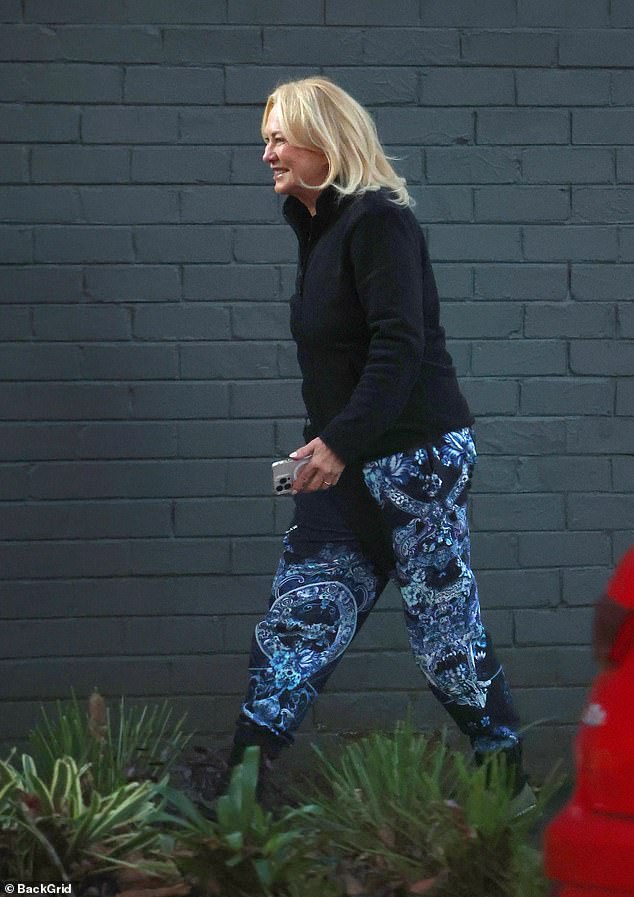 The blonde showed off her slim figure in black zip-up fleece and blue paisley print joggers