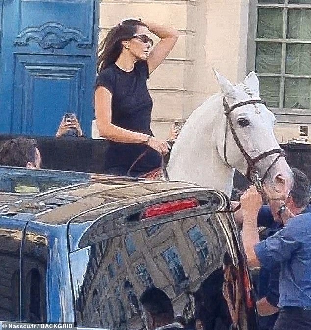 The model was assigned a white horse for the elite fashion event that would take place at the glitzy Place Vendome