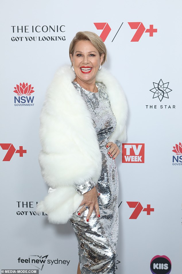 Julia dazzled in a striking dress with silver sequins, combined with a faux fur coat