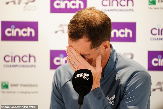 Andy Murray holds his head in his hands during a press conference after an injury forced him to retire from his maths against Jordan Thompson at Queen's Club on June 19.