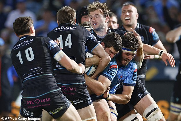 Marco van Staden is tackled by Warriors' Argentinian wing Sebastian Cancelliere