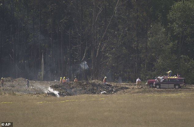Emergency crews mark the crash site of United Airlines Flight 93 near Shanksville, Pennsylvania, on the day it crashed.  Passengers on the flight overwhelmed Al Qaeda hijackers, causing the plane to nosedive into this field