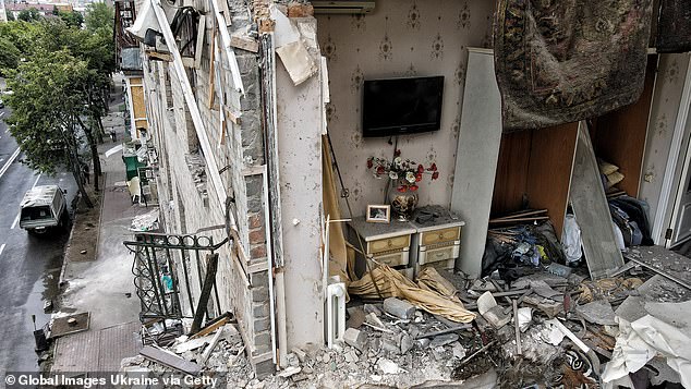 The destroyed remains of an apartment are exposed to the sky after Russian missiles damaged an apartment building in Kharkiv, Ukraine, on Sunday