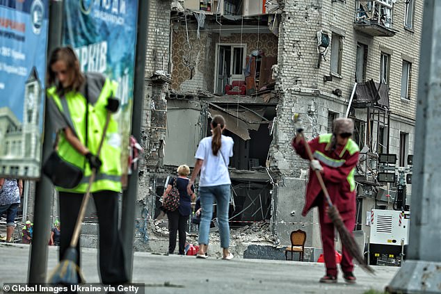 Ukrainians clean the streets and look at the damage caused by Russian bombs in Kharkiv on Sunday