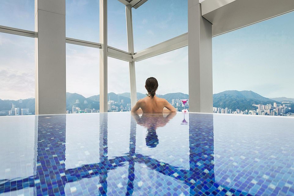 A guest (stock photo) enjoys the breathtaking view from the Ritz-Carlton pool