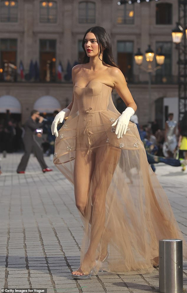 The supermodel put on a leggy show in the elegant semi-sheer petticoat underskirt