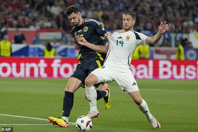 Varga, right, was seen battling for possession with Scot Scott McKenna of Scotland earlier in the match