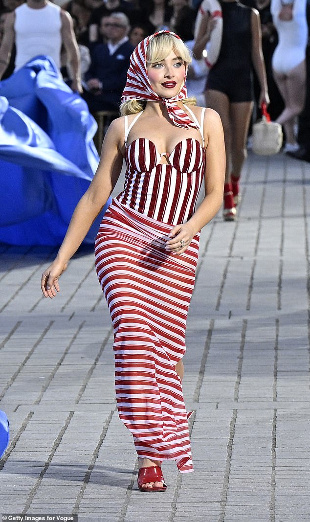 She struck the ultimate pose as she walked around center stage in red and white striped beachwear