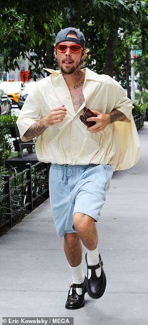 The Peaches artist sported a beard as he held his phone in his hand during a day out in New York