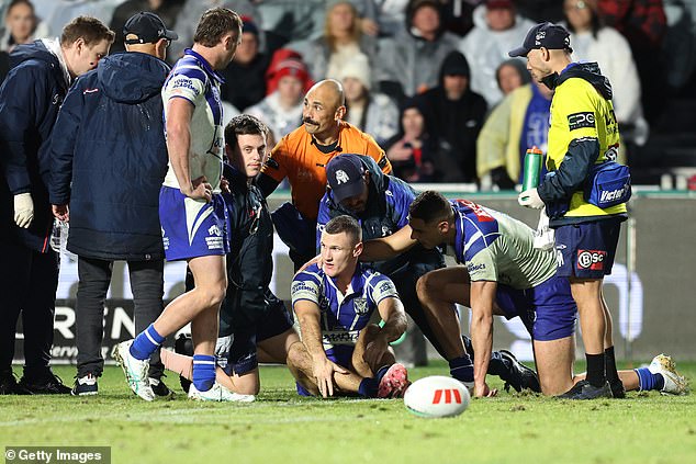 The shot prevented Tracey (pictured sitting on the floor, centre) from playing for the Bulldogs against the Sharks this week