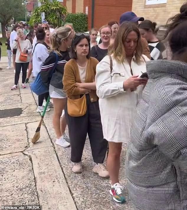 As Sydney faces a rental shortage and cost of living crisis, some people may buy apartments just for the parking space (photo of potential tenants queuing to inspect a Sydney property)