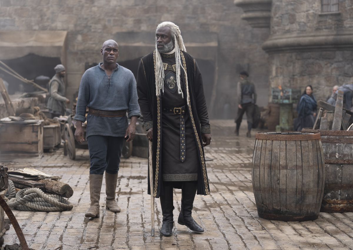 Steve Toussaint as Corlys Velaryon and Adubakar Salim as Addam of Hull walk together on a dock in House of the Dragon season 2 