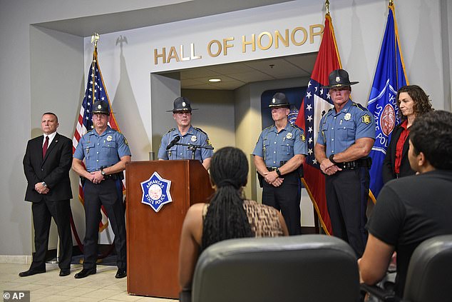 Col. Mike Hagar, center, at podium, answers media questions during a news conference Sunday about Friday's deadly shooting at an Arkansas supermarket
