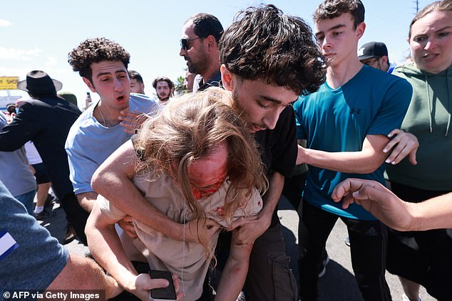 The protests quickly turned violent, with people throwing punches and a pro-Israel protester pictured with blood on his face