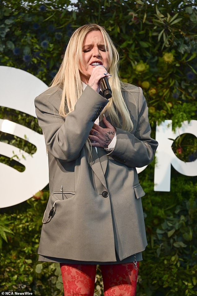 She completed her stylish look with a white button-up shirt and a long gray blazer