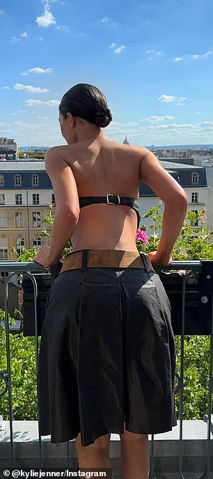 Jenner shared two more photos showing off her toned back as she looked over a balcony with a beautiful view