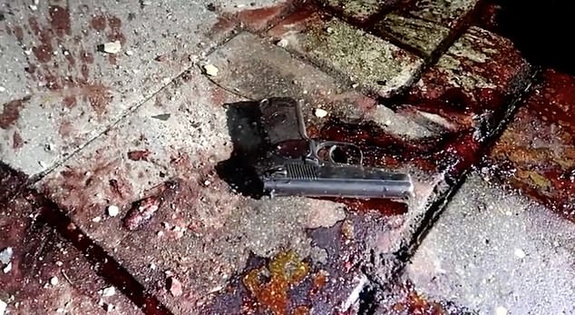 After the attacks, a police-issued pistol is seen on a blood-stained sidewalk in Dagestan