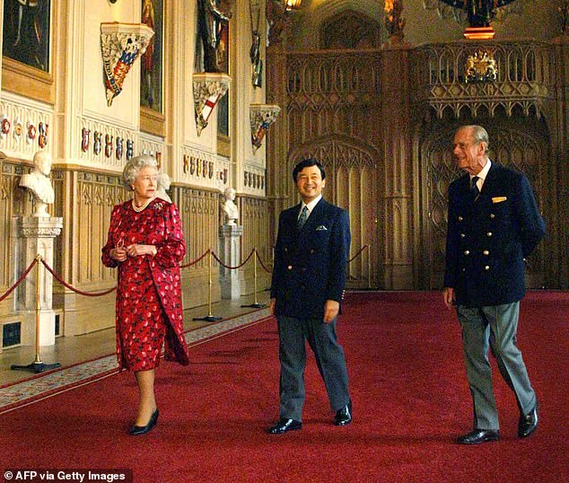 Naruhito walks past Windsor Castle with Queen Elizabeth and Prince Philip in 2001