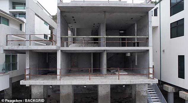 The inside of the house appears to be crumbling and the metal railings are rusting after being exposed to the salty air, wind and water