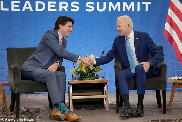 Canadian Prime Minister Justin Trudeau, pictured with President Joe Biden, has banned Chinese investors from buying property in his country after immigrants - mainly from Asia - caused property prices in the country to rise by almost 40 percent