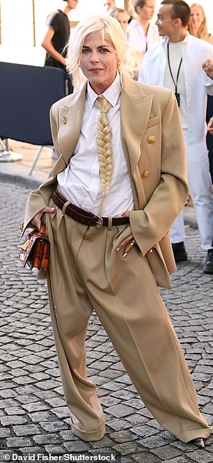 Selma, 52, opted for an androgynous look as she arrived to the show in a tan blazer and matching loose-fitting trousers