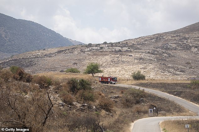 An Israeli fire truck drives towards an attack scene following a drone strike by Hezbollah from Lebanon on June 23, 2024