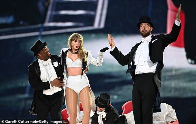 Taylor Swift is joined on stage by her boyfriend Travis Kelce during a costume change at Sunday's show