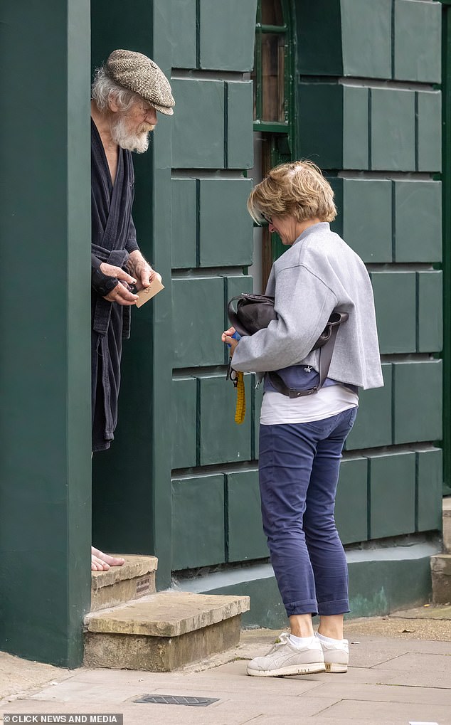 Sir Ian McKellen greets the friend who arrived at his home in London yesterday