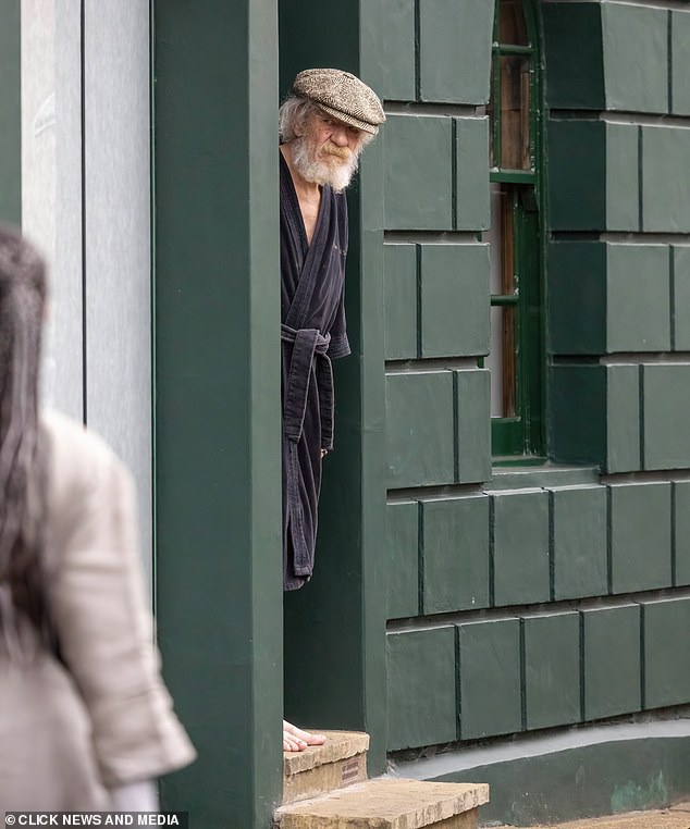 Sir Ian McKellen looks out from his home in London yesterday, almost a week after his accident