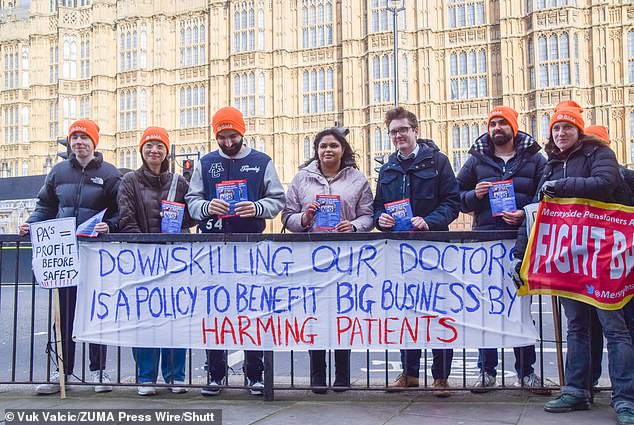 Protesters, including doctors, gathered outside Parliament in protest at the transfer of responsibilities to Physician Associates on February 26, 2024. Pictured is Dr Robert Laurenson (third from left), co-chair of the BMA Junior Doctors Committee, taking part in the protest