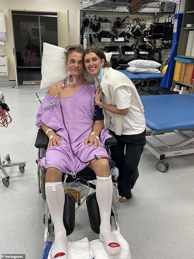 Johnny (pictured with fiancée Charlotte) is still paralyzed from the waist down at the Royal Brisbane and Women's Hospital