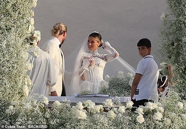 Diletta, 32, looked stunning as she opted for a backless wedding dress with long sleeves and intricate lace detailing