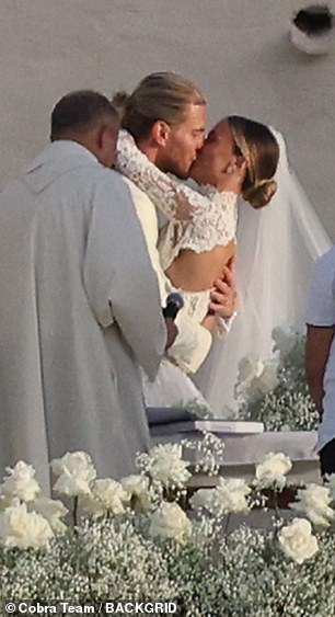 The couple embraced in a kiss during the sweet ceremony