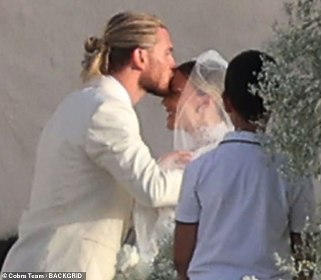 Lorius also planted a sweet kiss on his wife's forehead after they took their vows