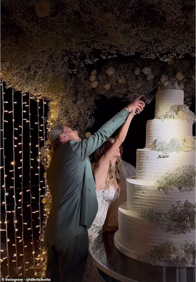 The pair shared a moment while cutting their giant cake