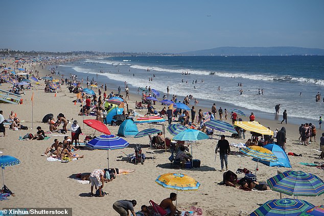 People cool off at Santa Monica Beach in Los Angeles, California